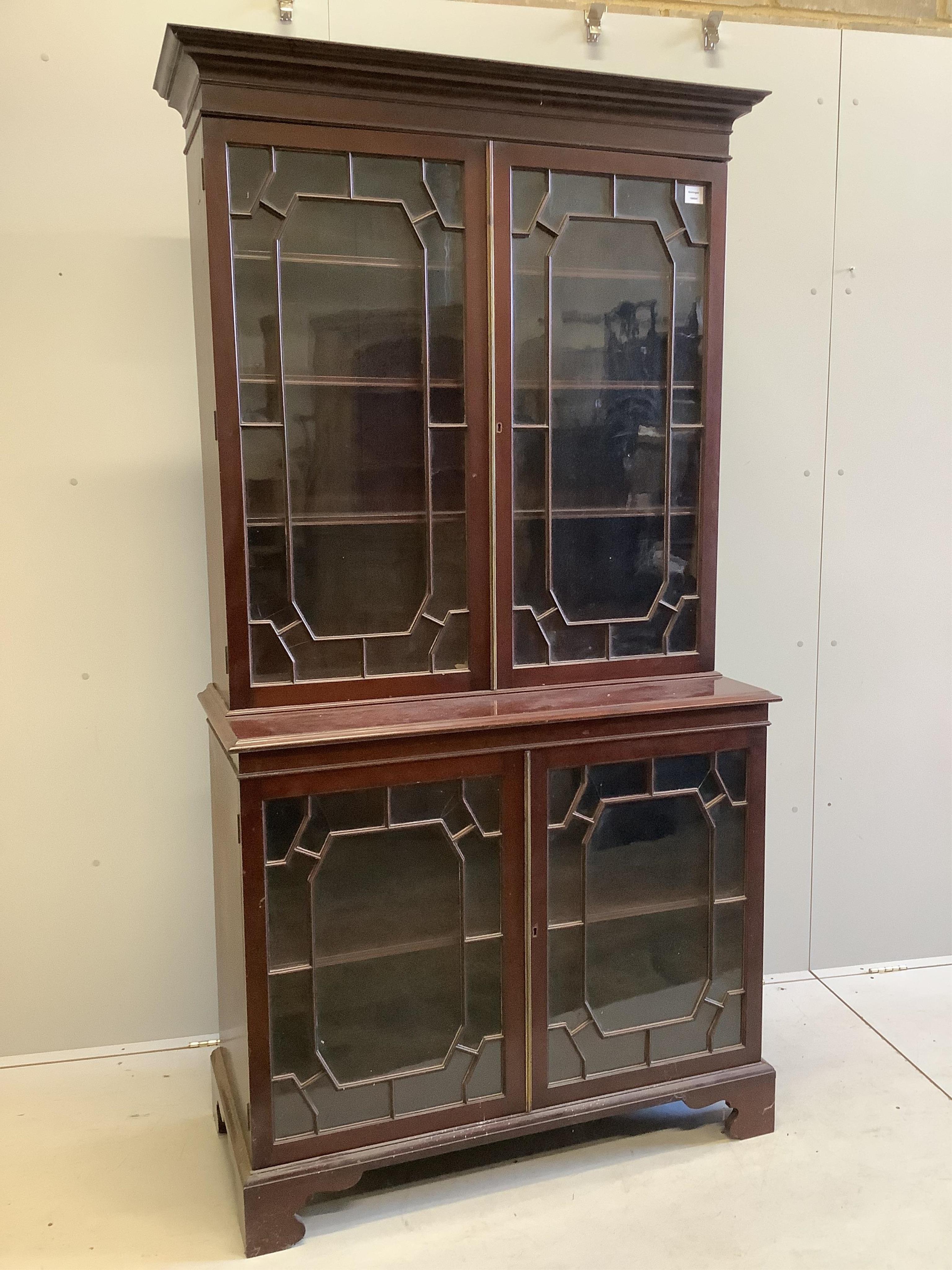 A George III style glazed mahogany bookcase, width 106cm, depth 48cm, height 206cm. Condition - fair